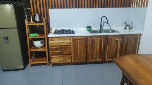 a kitchen with a sink and a stove and a refrigerator at Casa Osa Azul in Puerto Jiménez +55 photos
