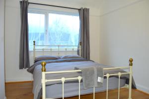 a bedroom with a bed and a window at East Croydon in South Norwood