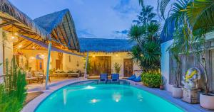 a house with a swimming pool in a yard at Luxury 3BR Villa Private Pool Ricefield Family-Friendly Near Canggu in Kerobokan