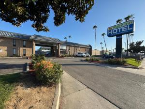a motel sign in front of a building at Palm Inn Hotel near Tyler Mall Riverside in Riverside