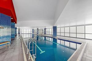 a large swimming pool in a large building at Cloud 56 Luxury Stay Level 56 with Free Onsite Parking in Brisbane