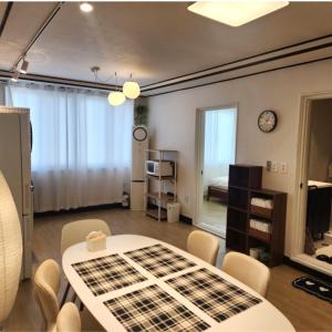 a room with a table and chairs and a bedroom at Brownie stay daegu banwoldang 3 rooms in Daegu