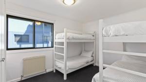 a room with two bunk beds and a window at Lawlers 30 in Mount Hotham
