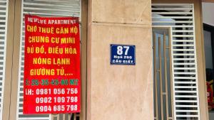a building with signs on the side of it at Era Apartment Chua Ha in Hanoi +39 photos