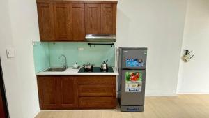 a small kitchen with a sink and a refrigerator at Era Apartment Chua Ha in Hanoi