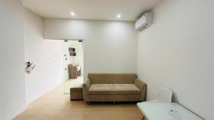 a living room with a couch and a table at Era Apartment Chua Ha in Hanoi