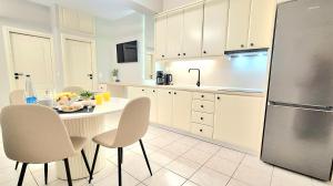 a kitchen with a table and chairs and a refrigerator at Philokali in Sitia