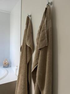 a bathroom with two towels hanging on a wall at Unique Australian Shed Style House in Dunsborough