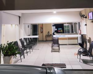 a waiting room with chairs and a counter in a hospital at Hotel Líder in Cáceres