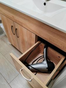 a hair dryer in a drawer under a sink at Bed Plus One in House in Richmond