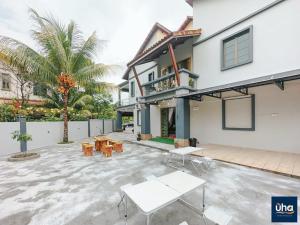 a house with a patio with tables and chairs at Bandar Dato Onn By UHA in Johor Bahru