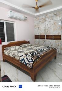a bedroom with a bed in a room at AJ srinivasa HOMESTAY in Tirupati