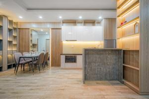 a kitchen and dining room with a table and chairs at RESidenza Condonium - D1mension & Zenity Tower, SG's Heart & Gym, Pool in Ho Chi Minh City