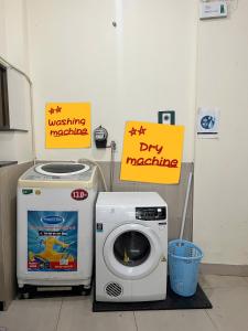 a washing machine and a dry machine with signs at FlexiHome in Ho Chi Minh City