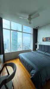 a bedroom with a bed and a large window at Sky Suites By JK in Kuala Lumpur
