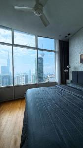 a bedroom with a large bed with a large window at Sky Suites By JK in Kuala Lumpur +9 photos