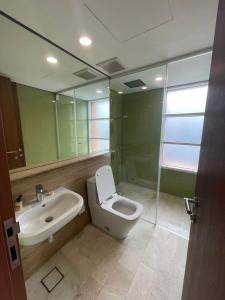 a bathroom with a toilet and a sink and a mirror at Sky Suites By JK in Kuala Lumpur