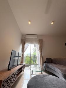 a living room with a couch and a tv at Elixia 3C'S by Planet Path in Sri Jayewardenepura Kotte +19 photos