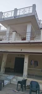 a large building with a balcony and two chairs at Sushma Homestay in Bhauvāpār