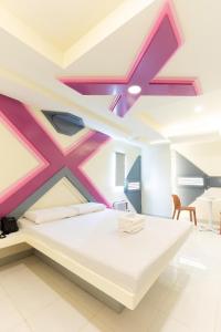 a bedroom with a large bed with a painting on the ceiling at Astrotel Cebu in Cebu City +5 photos