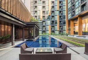 a swimming pool in the middle of a building at The Base Height Condo with Rooftop infinity pool in Ban Sam Kong