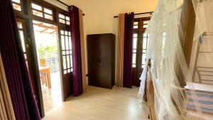 a wedding veil is hanging in a room with doors at DK Korean Apartment in Unawatuna