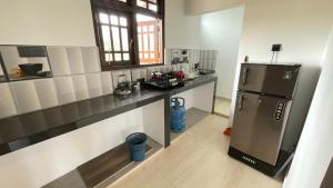 a kitchen with a refrigerator and a counter top at DK Korean Apartment in Unawatuna +37 photos