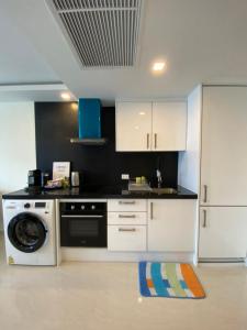 a kitchen with a washer and a dishwasher at Grand Avenue By MonthStayZ Thailand in Pattaya Central +179 photos