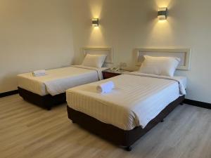 Postel nebo postele na pokoji v ubytování Hotel Ipoh City