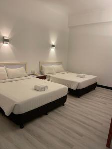 Postel nebo postele na pokoji v ubytování Hotel Ipoh City