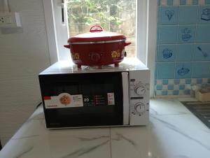 a pot on top of a microwave on a counter at Lanta Beautiful beach house in Ko Lanta