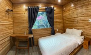 a bedroom with a bed and a desk and a window at Cat Ba Love House in Cat Ba +212 photos