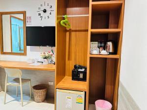 a wooden book shelf with a desk and a computer at PJ Patong Resortel in Patong Beach