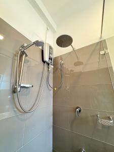 a shower with a shower head in a bathroom at Elixia 3C'S by Planet Path in Sri Jayewardenepura Kotte