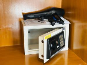 a microwave with a gun on top of it at PJ Patong Resortel in Patong Beach