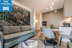 a living room with a couch and a table at Apartament Agat Lublin Centrum in Lublin