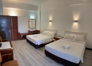 Postel nebo postele na pokoji v ubytování Hotel Ipoh City
