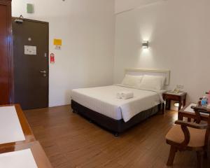 Postel nebo postele na pokoji v ubytování Hotel Ipoh City