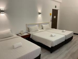 Postel nebo postele na pokoji v ubytování Hotel Ipoh City + 8 fotografií