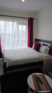 a bedroom with a large bed and a window at Delight stays in Ongata Rongai 
