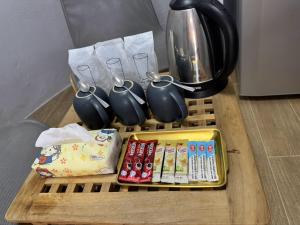 a table with a tray with utensils and a coffee pot at บ้านดิน 2 ชั้น in Khanong Phra +8 photos