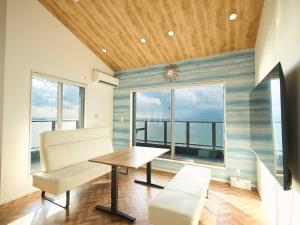 a dining room with a table and a large window at Blue Ocean Awaji in Sumoto