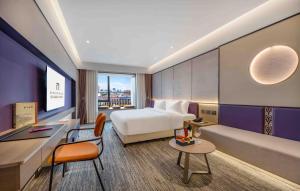 Postel nebo postele na pokoji v ubytování New Century Mansion Hotel Nanxun Shuijingjing