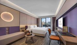Postel nebo postele na pokoji v ubytování New Century Mansion Hotel Nanxun Shuijingjing