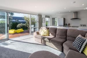 a living room with a couch and a kitchen at 18 on Burgundy in Martinborough 