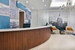 an office lobby with a reception counter and chairs at The Connally Hotel Downtown Atlanta, an Ascend Collection Hotel in Atlanta