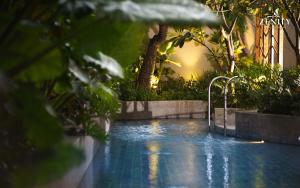 a swimming pool in the middle of a garden at RESidenza Condonium - D1mension & Zenity Tower, SG's Heart & Gym, Pool in Ho Chi Minh City