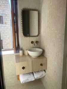 a bathroom with a sink and a mirror at SPITI Urania in Kathikas