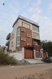 a building on the side of a street at MM Beach House & Party Hall in Chennai