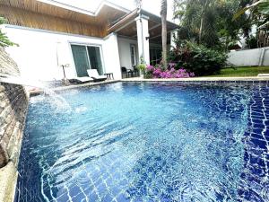 a swimming pool with a waterfall in a house at VILLA CHELONI 2 BEDROOMS in Kamala Beach